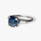 14k White Gold Round Blue Sapphire and Tapered Baguette Diamond Three-Stone Ring Side View