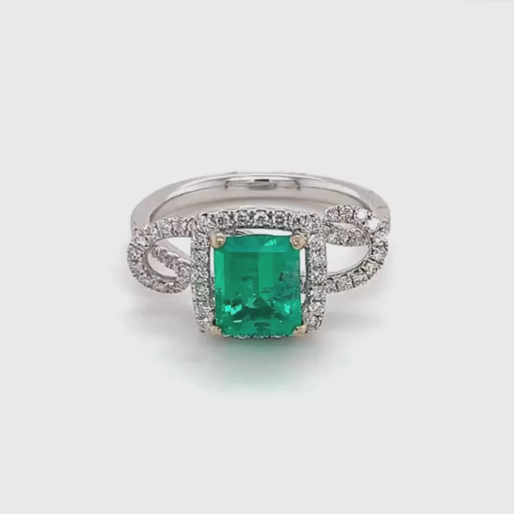 18k White Gold Emerald Cut Emerald and Diamond Halo Twisted Ring